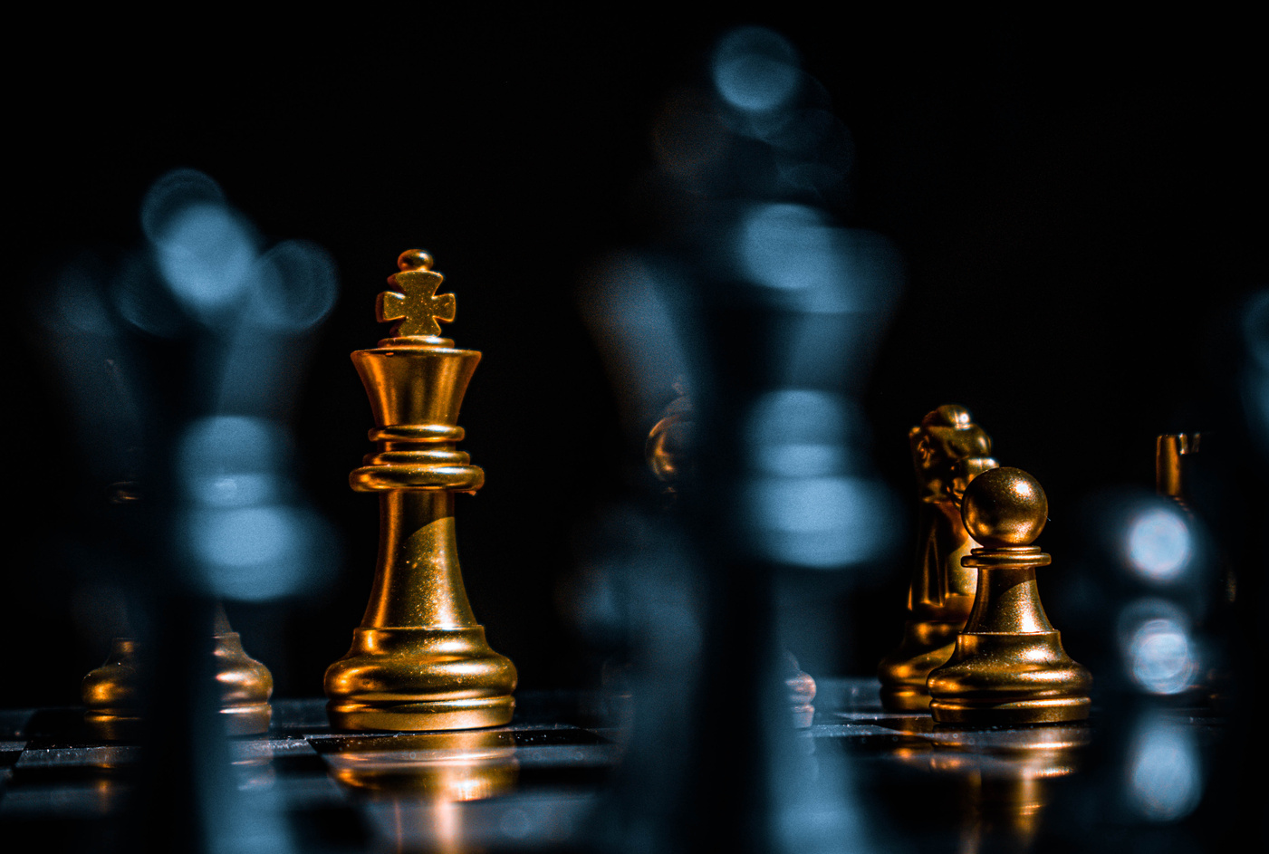 Gold Chess Pieces on Black Surface